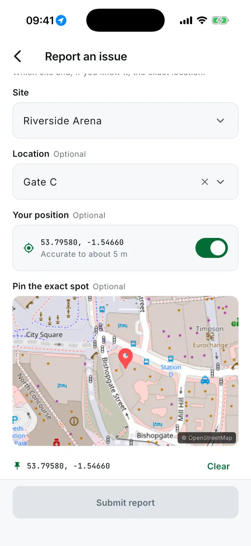 The report form with Riverside Arena, Gate C, the phone's position switched on and a pin dropped on the map.